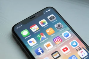 Celular com tela ligada e diversos aplicativos no segundo plano Source: Unsplash